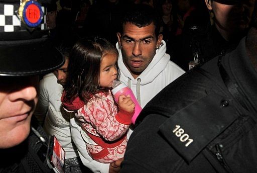 Carlos Tevez arrives back at Manchester airport earlier this month
