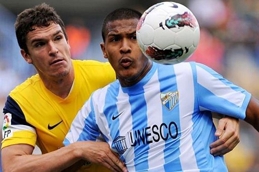 Real Sociedad's Jon Ansotegi (L) vies with Malaga's Salomon Rondon