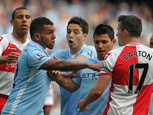 Queens Park Rangers' Joey Barton (R) clashes with Manchester City's Carlos Tevez (2nd L) Queens Park Rangers' Joey Barton (R) clashes with Manchester City's Carlos Tevez (2nd L)