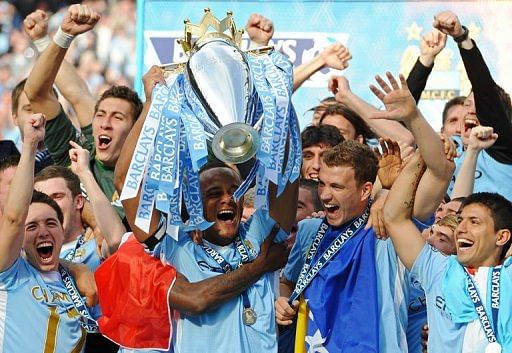 Manchester City's captain Vincent Kompany lifts the Premier league trophy Manchester City's captain Vincent Kompany lifts the Premier league trophy