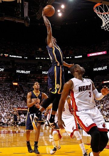 Paul George of the Indiana Pacers dunks over Dwyane Wade of the Miami Heat Paul George of the Indiana Pacers dunks over Dwyane Wade of the Miami Heat
