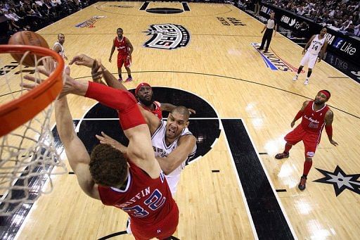 Tim Duncan of the San Antonio Spurs takes a shot against Blake Griffin of the Los Angeles Clippers Tim Duncan of the San Antonio Spurs takes a shot against Blake Griffin of the Los Angeles Clippers