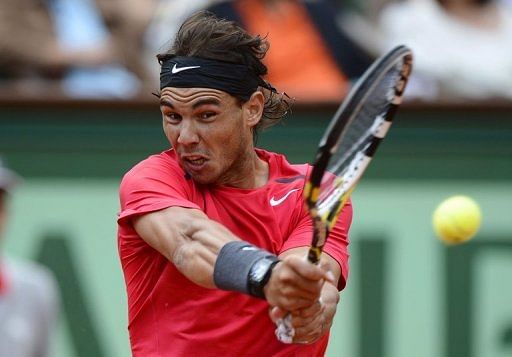 Nadal smashes a return to Ferrer shortly before the match was briefly halted due to rain on Friday Nadal smashes a return to Ferrer shortly before the match was briefly halted due to rain on Friday