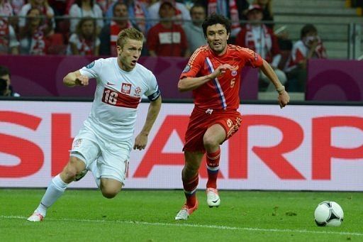 Poland's Jakub Blaszczykowski (L) vies with Russia's Sergey Ignashevich Poland's Jakub Blaszczykowski (L) vies with Russia's Sergey Ignashevich