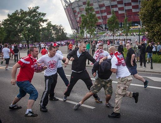 Polish football fans beat a Russian football fan during clashes in Warsaw on June 12 Polish football fans beat a Russian football fan during clashes in Warsaw on June 12