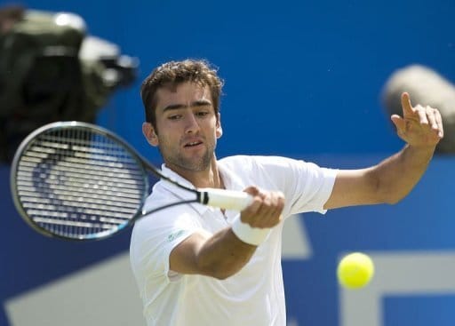 Croatia's Marin Cilic hits a return against American Sam Querrey at Queen's