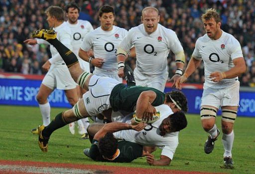 England's Jonathan Joseph is tackled by a member of the South Africa team England's Jonathan Joseph is tackled by a member of the South Africa team