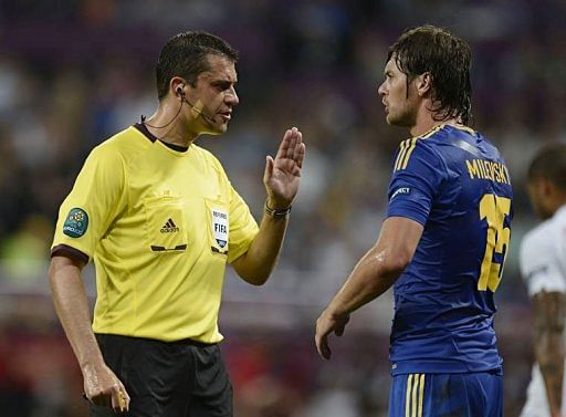 Hungarian referee Viktor Kassai gestures to Ukrainian forward Artem Milevskiy during the match Hungarian referee Viktor Kassai gestures to Ukrainian forward Artem Milevskiy during the match