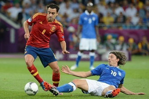 Spain's Xavi Hernandez evades a tackle from Italy's Riccardo Montolivo in Sunday's final Spain's Xavi Hernandez evades a tackle from Italy's Riccardo Montolivo in Sunday's final