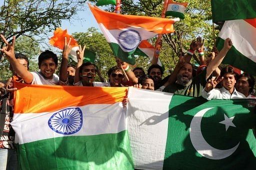 Cricket fans wave Indian and Pakistani flags ahead of the World Cup semi-final between the sides in Mohali in 2011