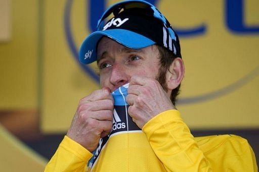 British Bradley Wiggins, kisses his jersey as he celebrates on the podium British Bradley Wiggins, kisses his jersey as he celebrates on the podium