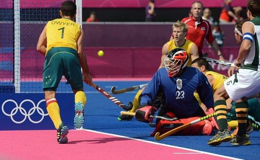 Australia's Jamie Dwyer scores one of his three goals against South Africa on Monday Australia's Jamie Dwyer scores one of his three goals against South Africa on Monday
