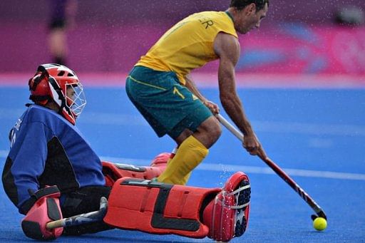 Australia's midfielder Jamie Dwyer (R) takes a shot against South Africa's goalkeeper Erasmus Pieterse Australia's midfielder Jamie Dwyer (R) takes a shot against South Africa's goalkeeper Erasmus Pieterse