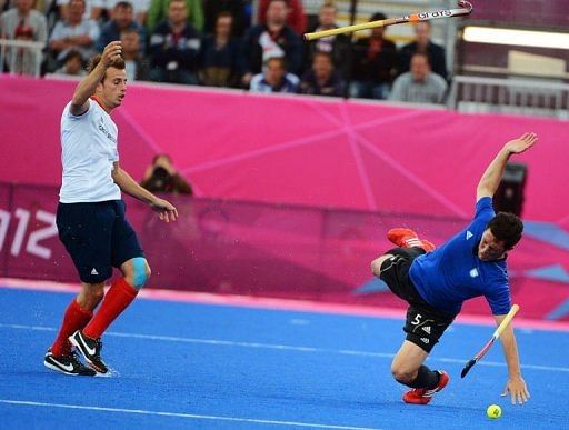 Great Britain's Matt Daly (L) vies for the ball with Argentina's Pedro Ibarra (R) Great Britain's Matt Daly (L) vies for the ball with Argentina's Pedro Ibarra (R)