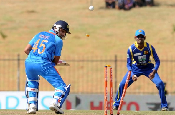 Indian cricketer Rohit Sharma (L) is bow