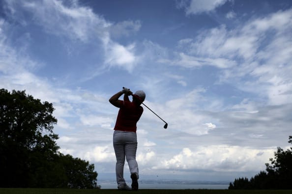 A professional golfer hits a drive durin