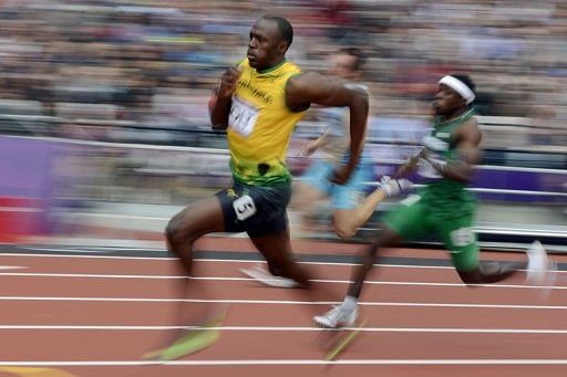 Jamaica's Usain Bolt (L) and Nigeria's Noah Akwu (R) compete in the men's 200m heats Jamaica's Usain Bolt (L) and Nigeria's Noah Akwu (R) compete in the men's 200m heats