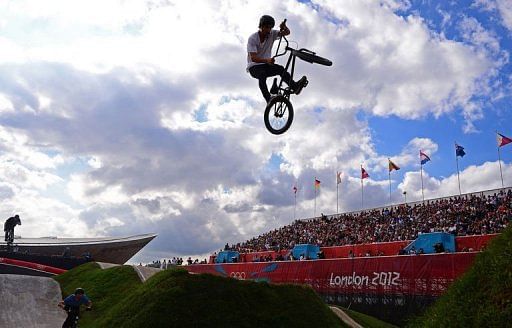 A freestyle BMX rider entertains the crowds during a break in the BMX cycling seeding phase runs A freestyle BMX rider entertains the crowds during a break in the BMX cycling seeding phase runs
