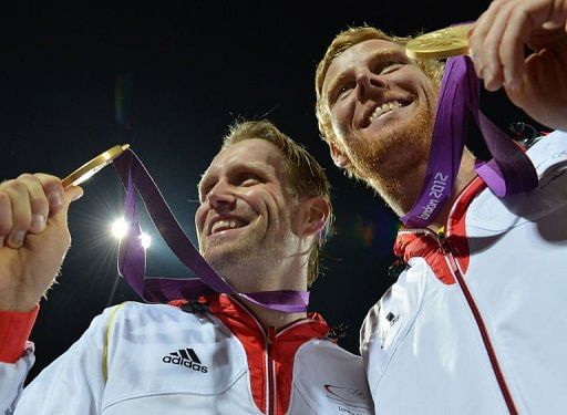 Germany's Jonas Reckermann (R) and Julius Brink (L) pose with their gold medals Germany's Jonas Reckermann (R) and Julius Brink (L) pose with their gold medals