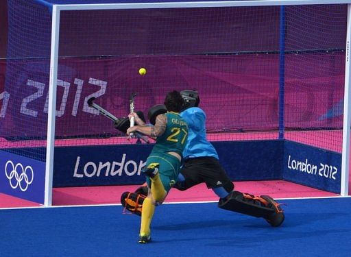 Australia's midfielder Kieran Govers scores past Britain's goalkeeper James Fair Australia's midfielder Kieran Govers scores past Britain's goalkeeper James Fair