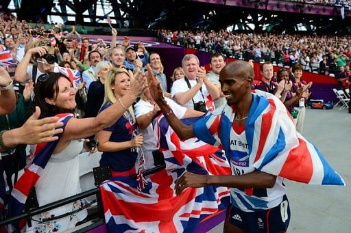 Britain's Mohamed Farah (R) celebrates with spectators Britain's Mohamed Farah (R) celebrates with spectators