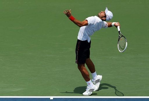 Novak Djokovic of Serbia serves Novak Djokovic of Serbia serves