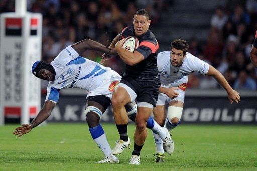 Toulouse's centre Luke McAllister (C) breaks away from Castres' flanker Ibrahim Diarra (L) and fly-half Remi Tales Toulouse's centre Luke McAllister (C) breaks away from Castres' flanker Ibrahim Diarra (L) and fly-half Remi Tales