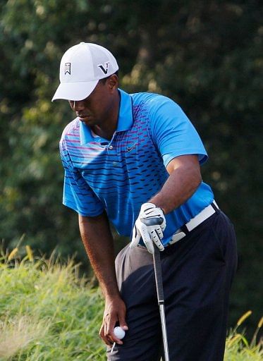 Tiger Woods defied a sore back to shoot a two-under 69 to join a group sharing seventh on five-under 137 Tiger Woods defied a sore back to shoot a two-under 69 to join a group sharing seventh on five-under 137