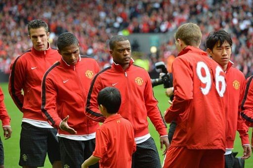 Manchester United defender Patrice Evra (3rd L) waits to shakes hands with Liverpool's Steven Gerrard (2nd right) Manchester United defender Patrice Evra (3rd L) waits to shakes hands with Liverpool's Steven Gerrard (2nd right)