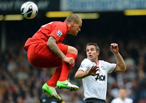 Liverpool's Martin Skrtel (L) vies with Manchester United's Robin van Persie Liverpool's Martin Skrtel (L) vies with Manchester United's Robin van Persie