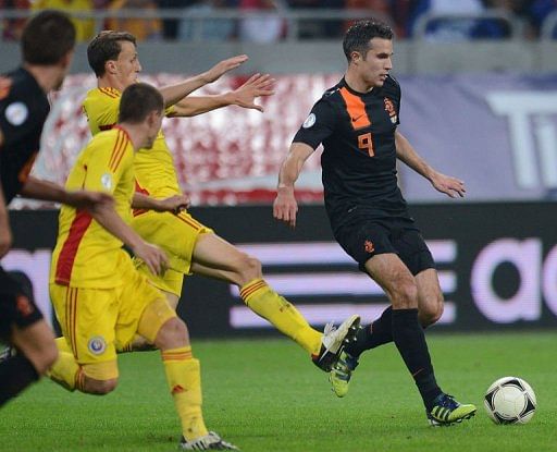 Robin van Persie (R) of the Netherlands runs with the ball Robin van Persie (R) of the Netherlands runs with the ball