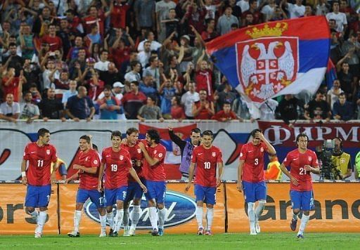 Serbia's players celebrate a goal in September Serbia's players celebrate a goal in September
