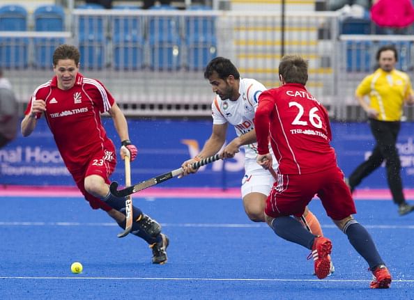 India's Tushar Khandker (C) dribbles the