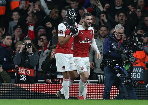 Aubameyang celebrates his second goal with Sead Kolasinac to gift Arsenal a slender lead over the two legs