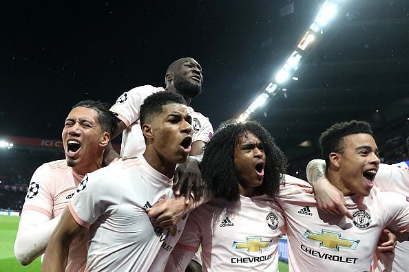 Rashford (second from left) and his teammates celebrate the 21-year-old's stoppage-time penalty