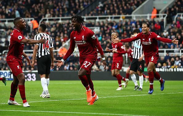 Divock Origi wheels away to celebrate his last-gasp effort, snatching all three points for Liverpool
