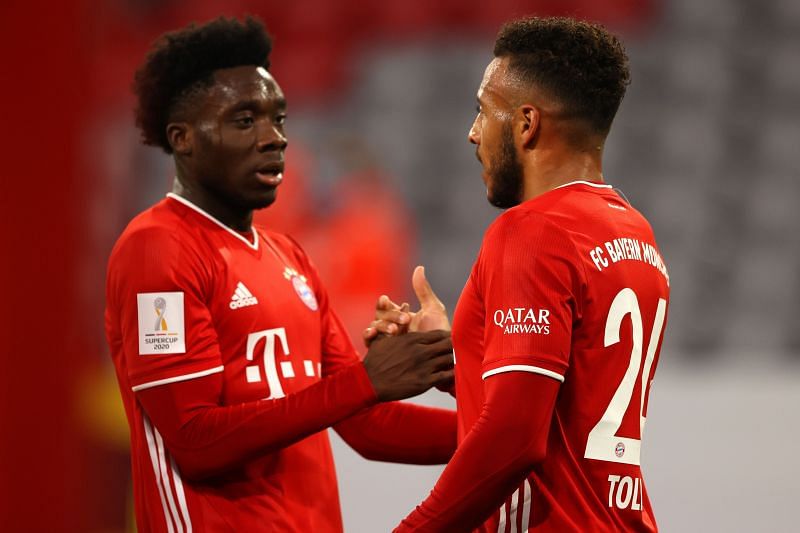 Davies celebrates with Tolisso after a lightning counter-attack was finished during an eventful first-half