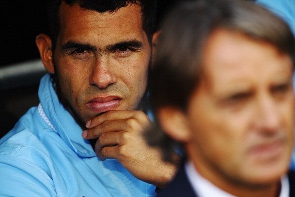 How did Carlos Tevez get a burn scar on his neck?