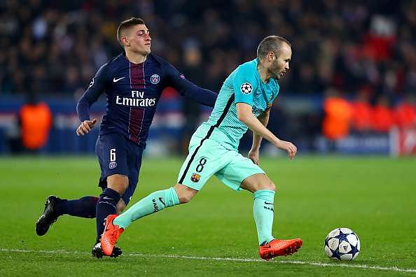 Andres Iniesta of Barcelona battles for the ball with Marco Verratti ...